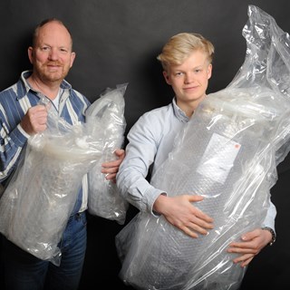 stobbe and son with fermenters.JPG